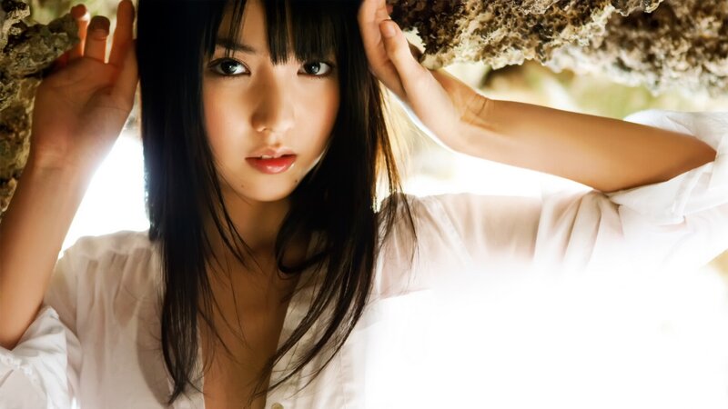 woman in white shirt under rock