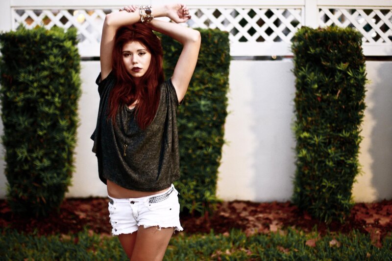 woman in white shorts posing outdoors