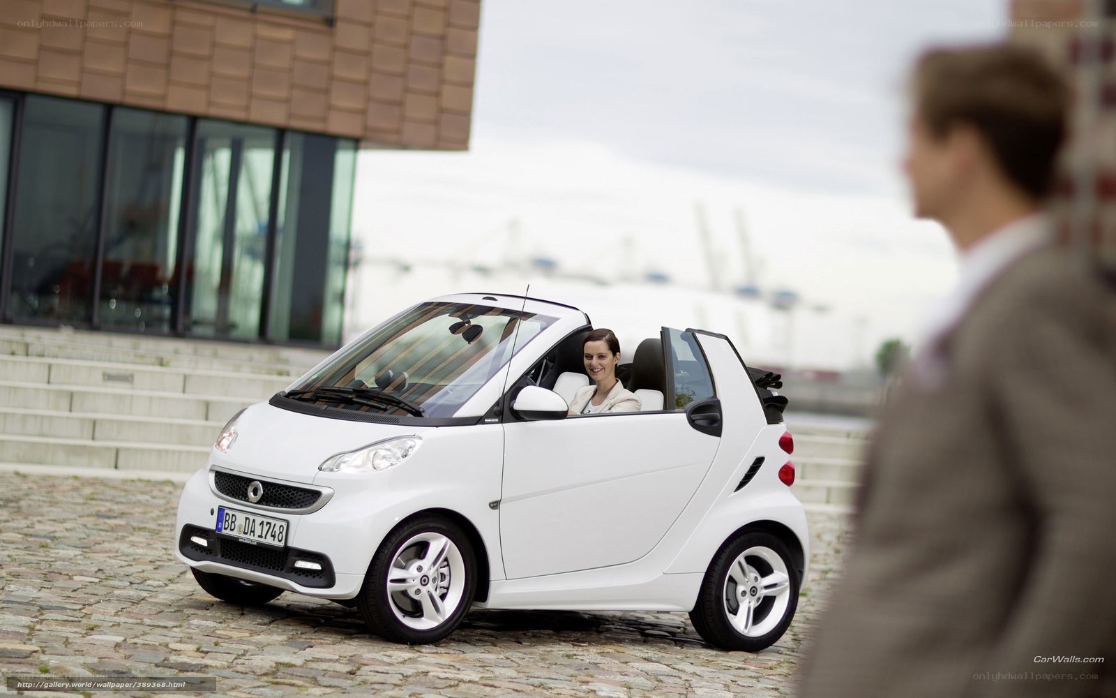 Woman in white smart car