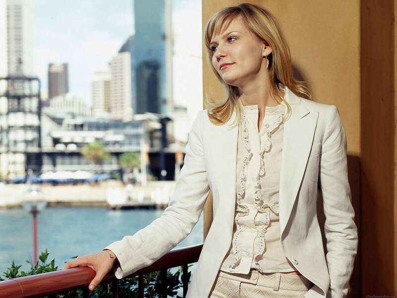 woman in white suit by water
