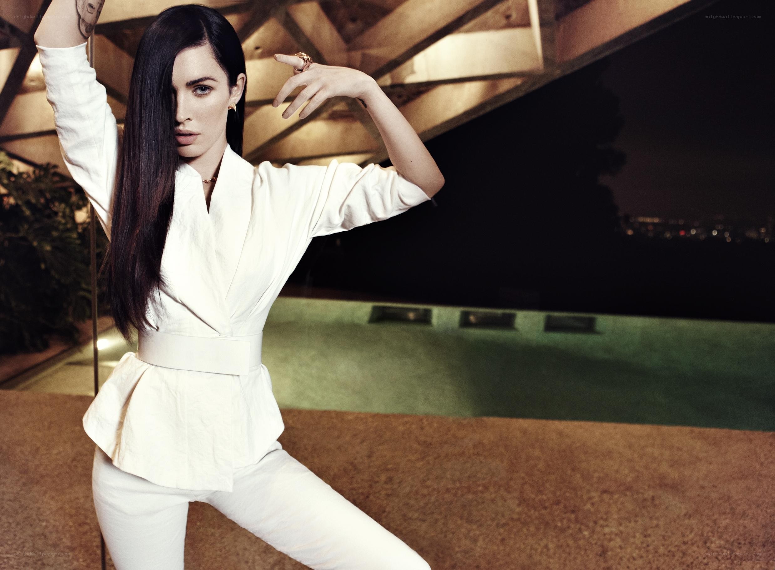 woman in white suit posing