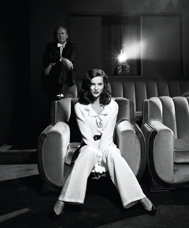 Woman in white suit seated