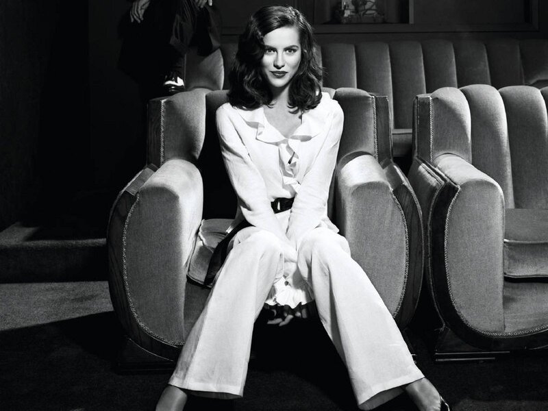 Woman in white suit sitting