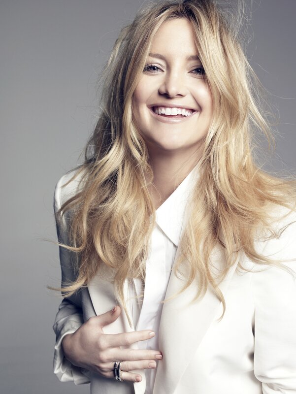 woman in white suit smiling