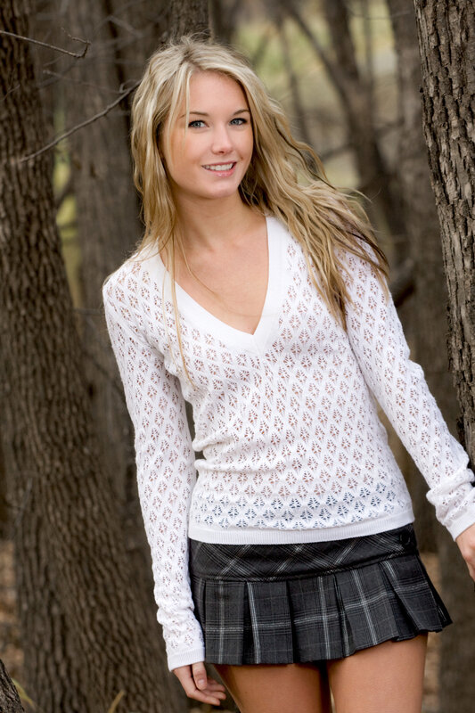 Woman in white sweater and plaid skirt
