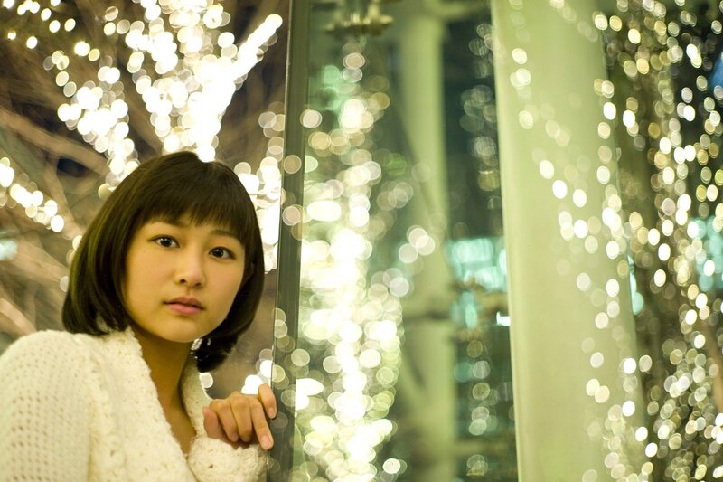 woman in white sweater at night
