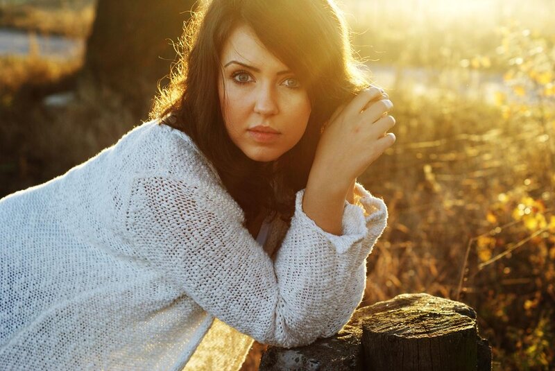 woman in white sweater at sunset