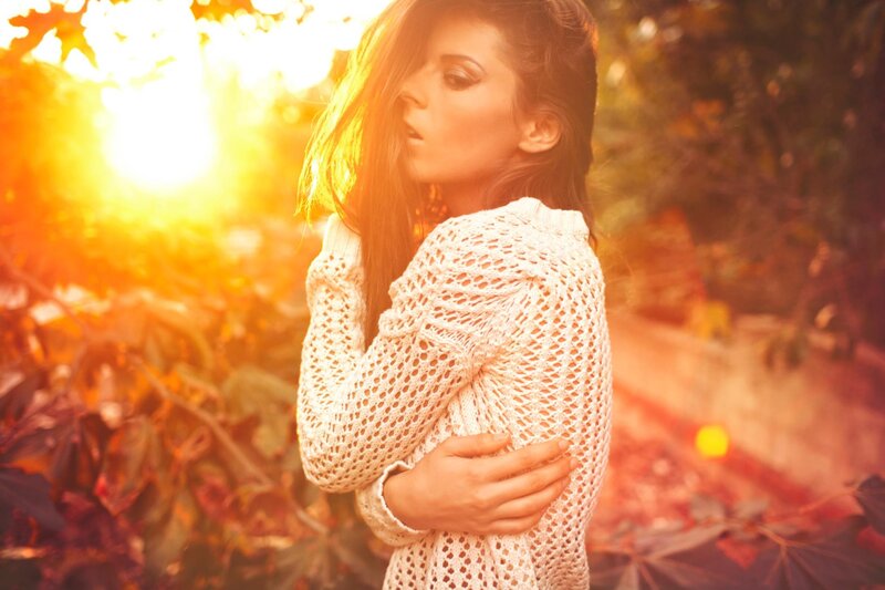 woman in white sweater at sunset