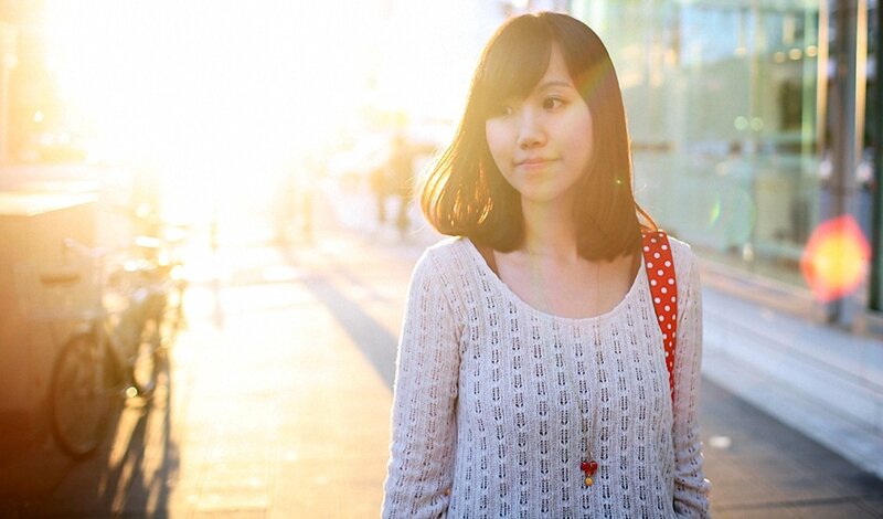 woman in white sweater at sunset