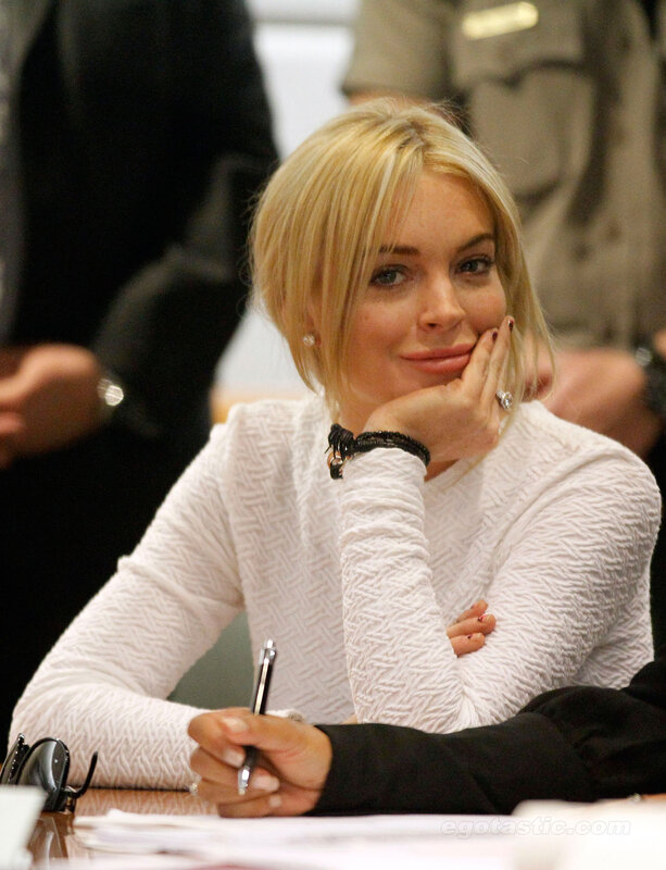 woman in white sweater at table