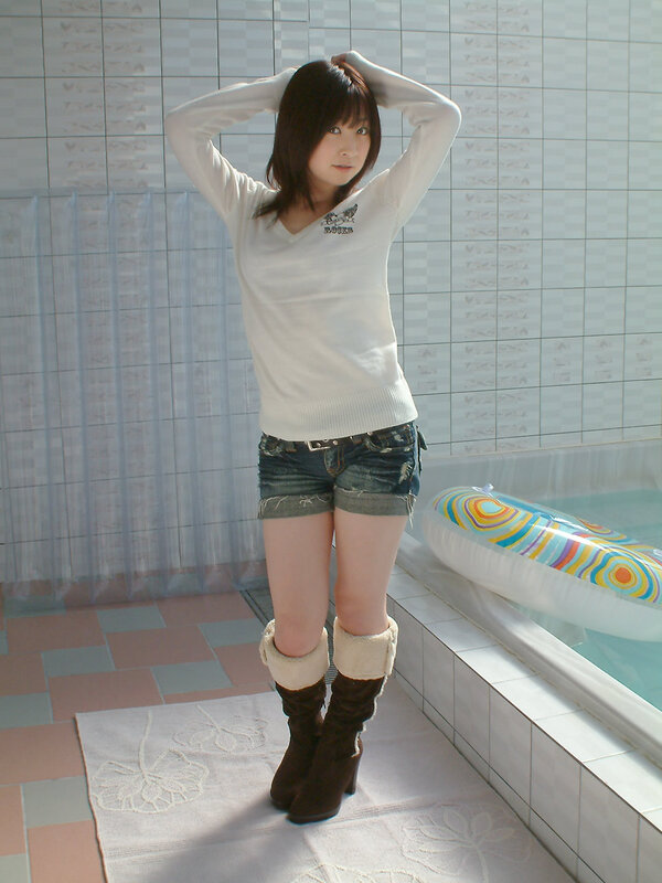 woman in white sweater by pool