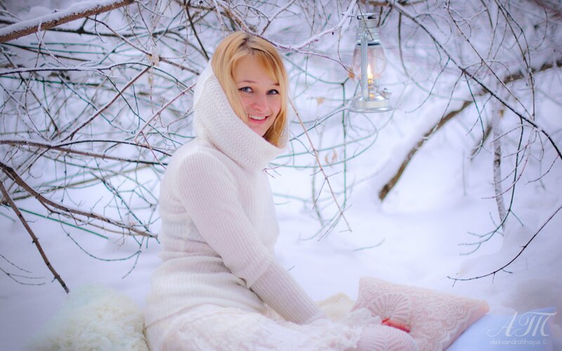 Woman in white sweater in snow