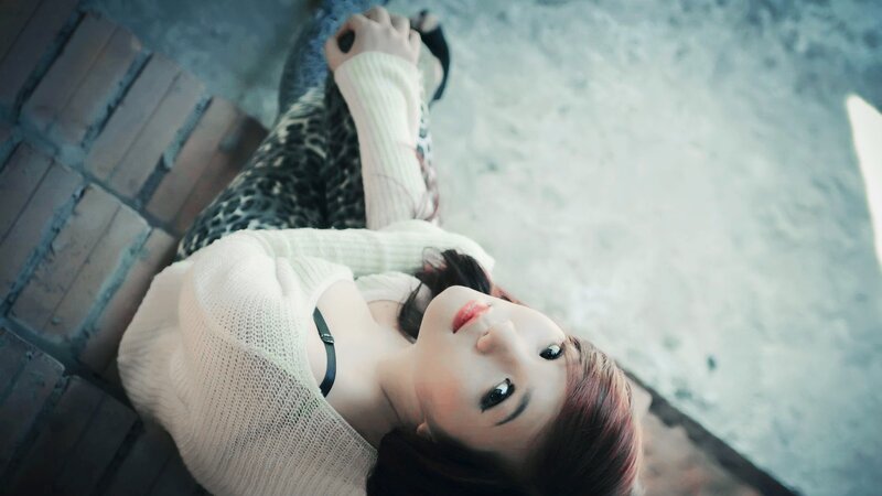 woman in white sweater lying down