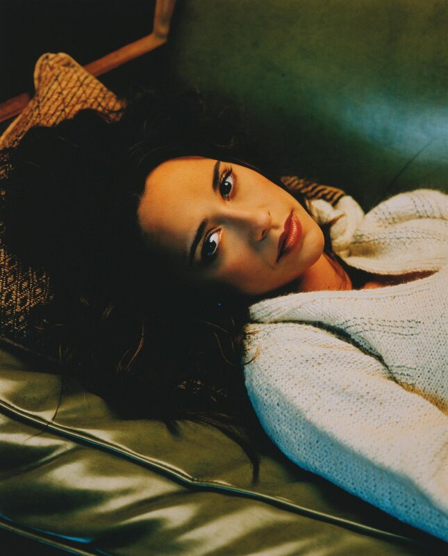 woman in white sweater lying down
