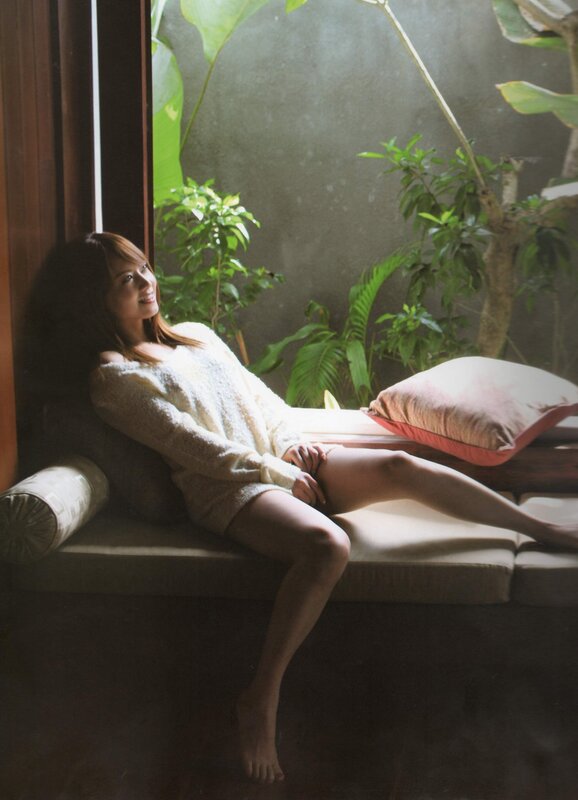 Woman in white sweater on bench