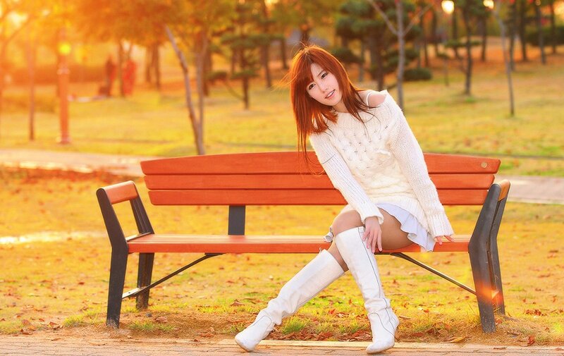 Woman in white sweater on bench