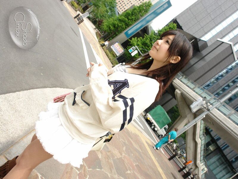 Woman in white sweater on city street