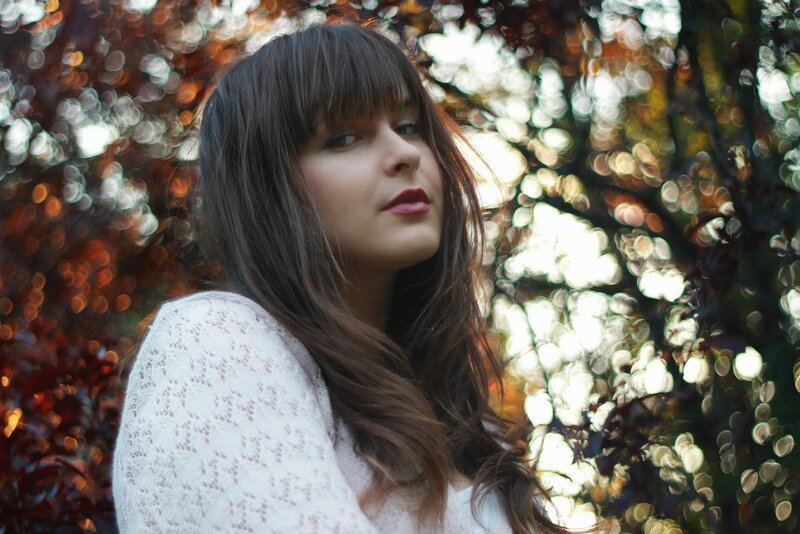 woman in white sweater outdoors