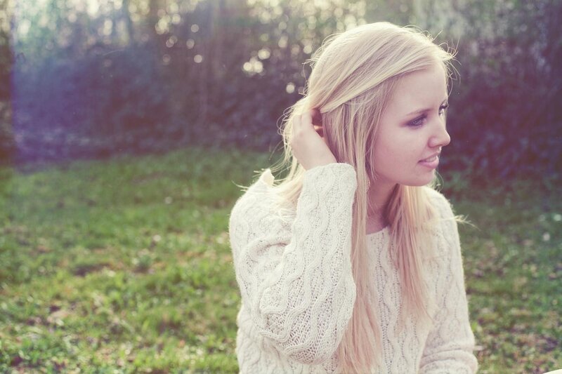 woman in white sweater outdoors
