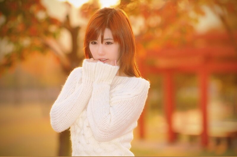 woman in white sweater outdoors