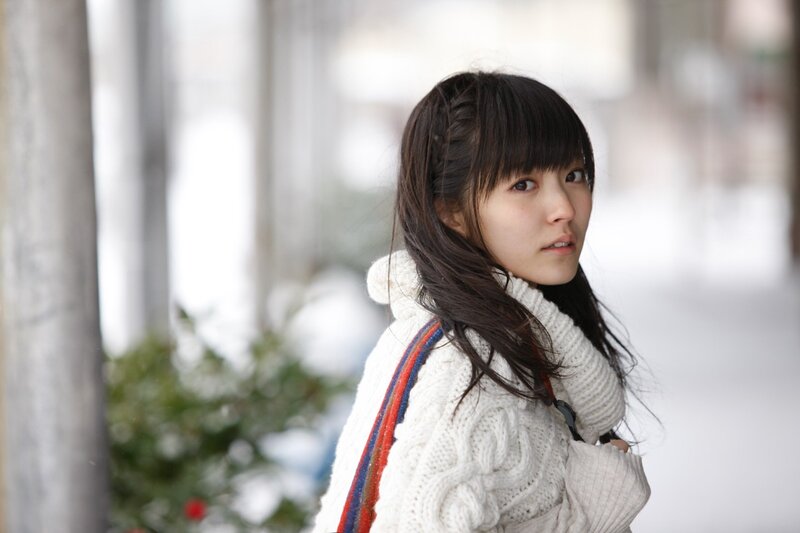 woman in white sweater outdoors