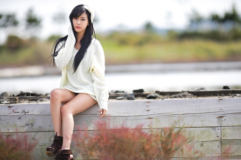 woman in white sweater sitting