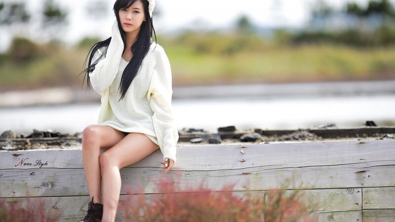 woman in white sweater sitting
