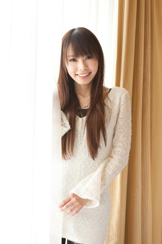 woman in white sweater smiling