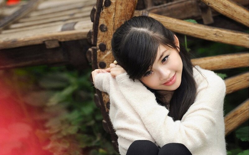 woman in white sweater smiling