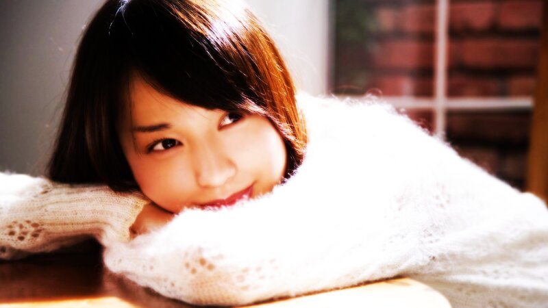 woman in white sweater smiling