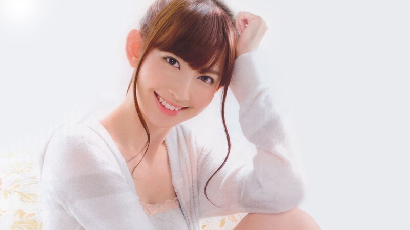 woman in white sweater smiling