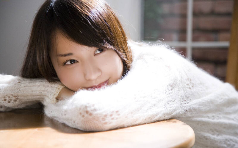 woman in white sweater smiling
