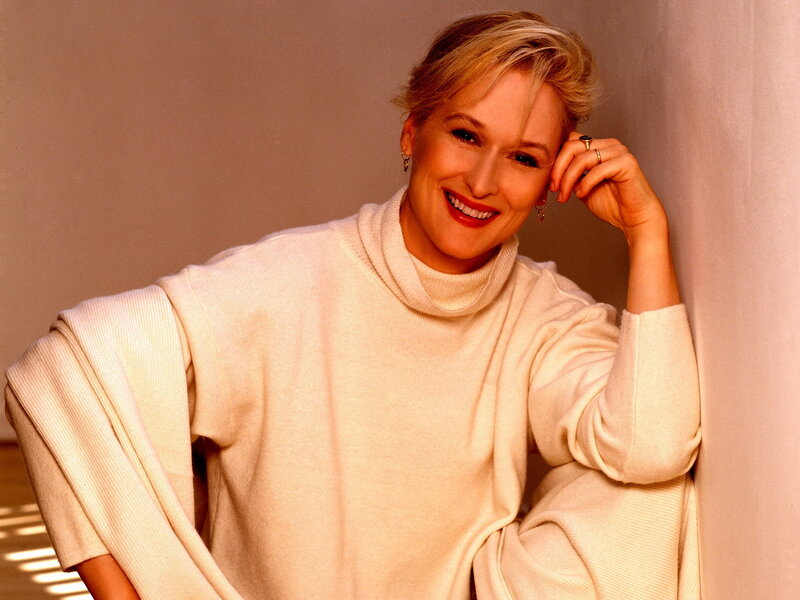 woman in white sweater smiling
