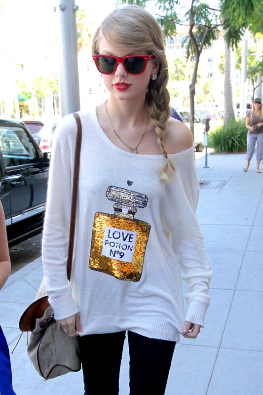 woman in white sweater with perfume design
