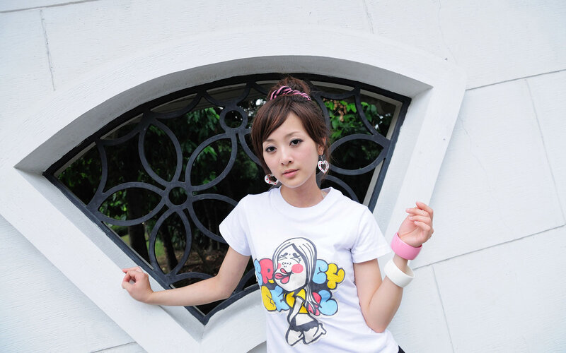 woman in white t-shirt by window