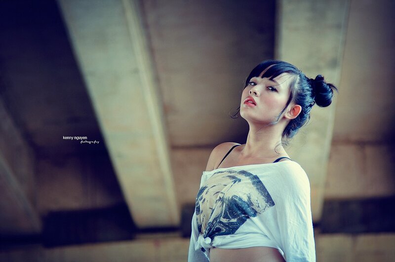 woman in white t-shirt under bridge
