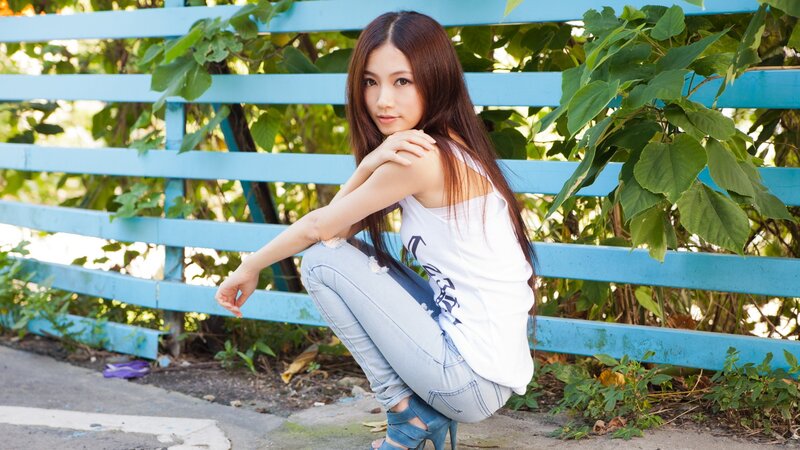 woman in white tank top crouching