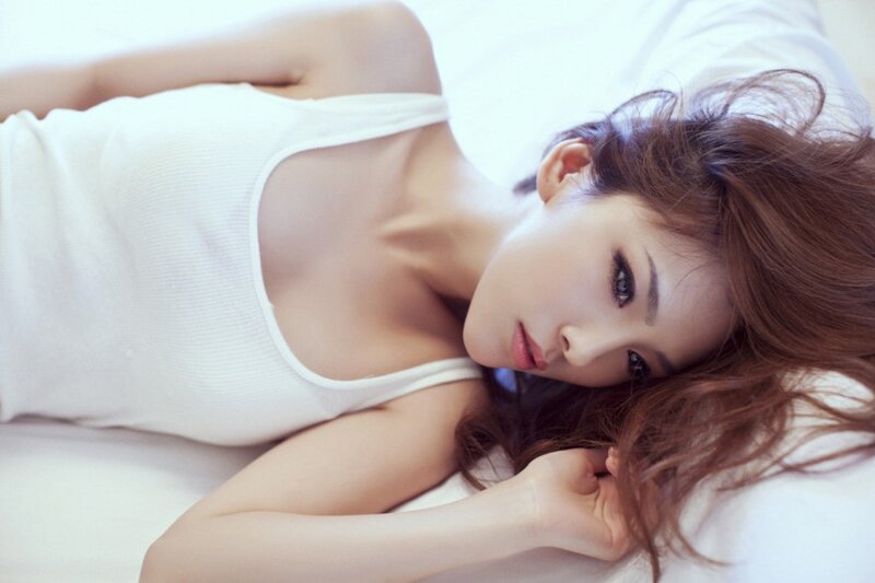woman in white tank top lying down