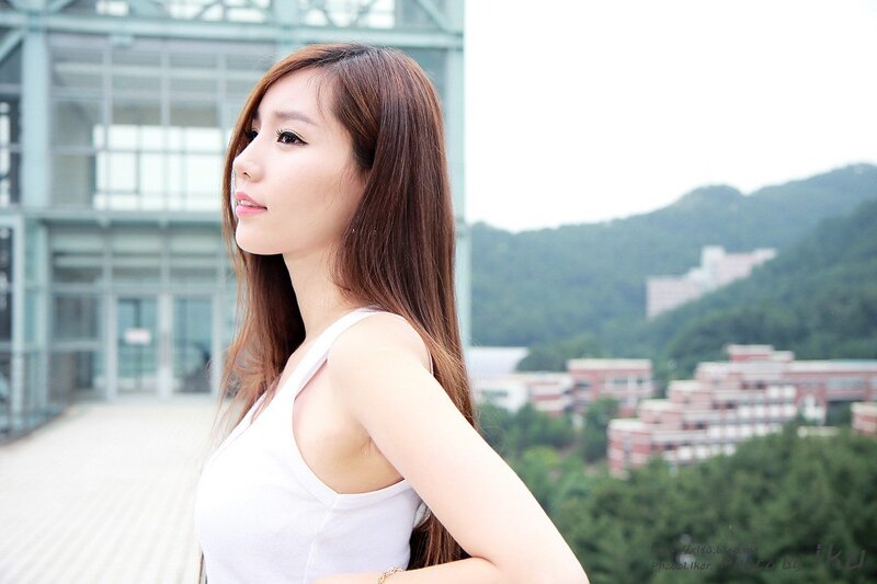 Woman in White Tank Top — Serene, Afternoon, Photograph, Building