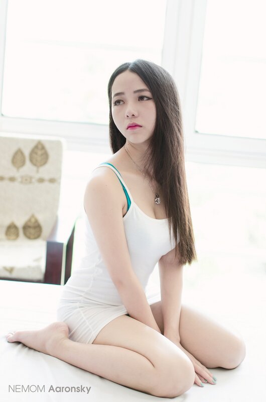 woman in white tank top sitting