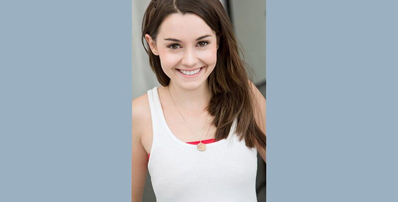 woman in white tank top smiling