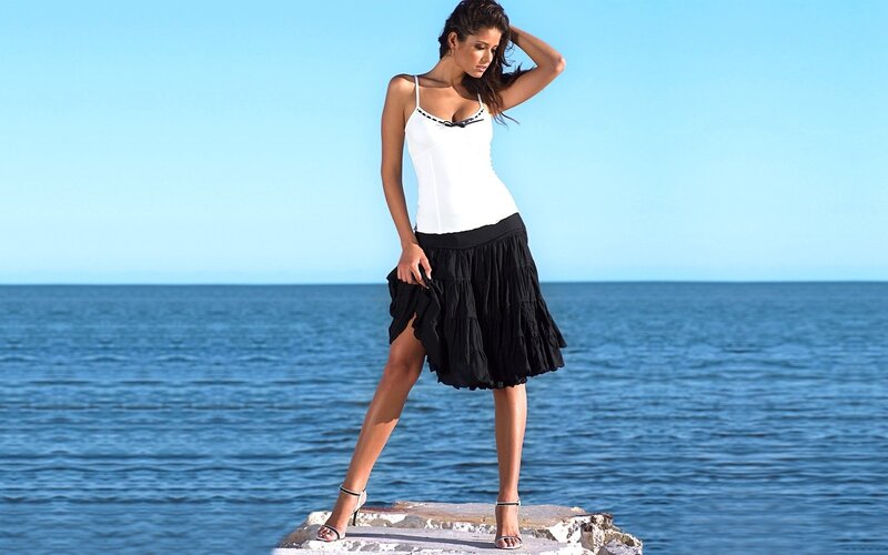 Woman in white top and black skirt