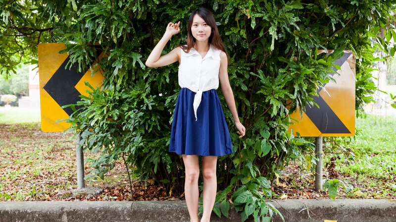 Woman in white top and blue skirt