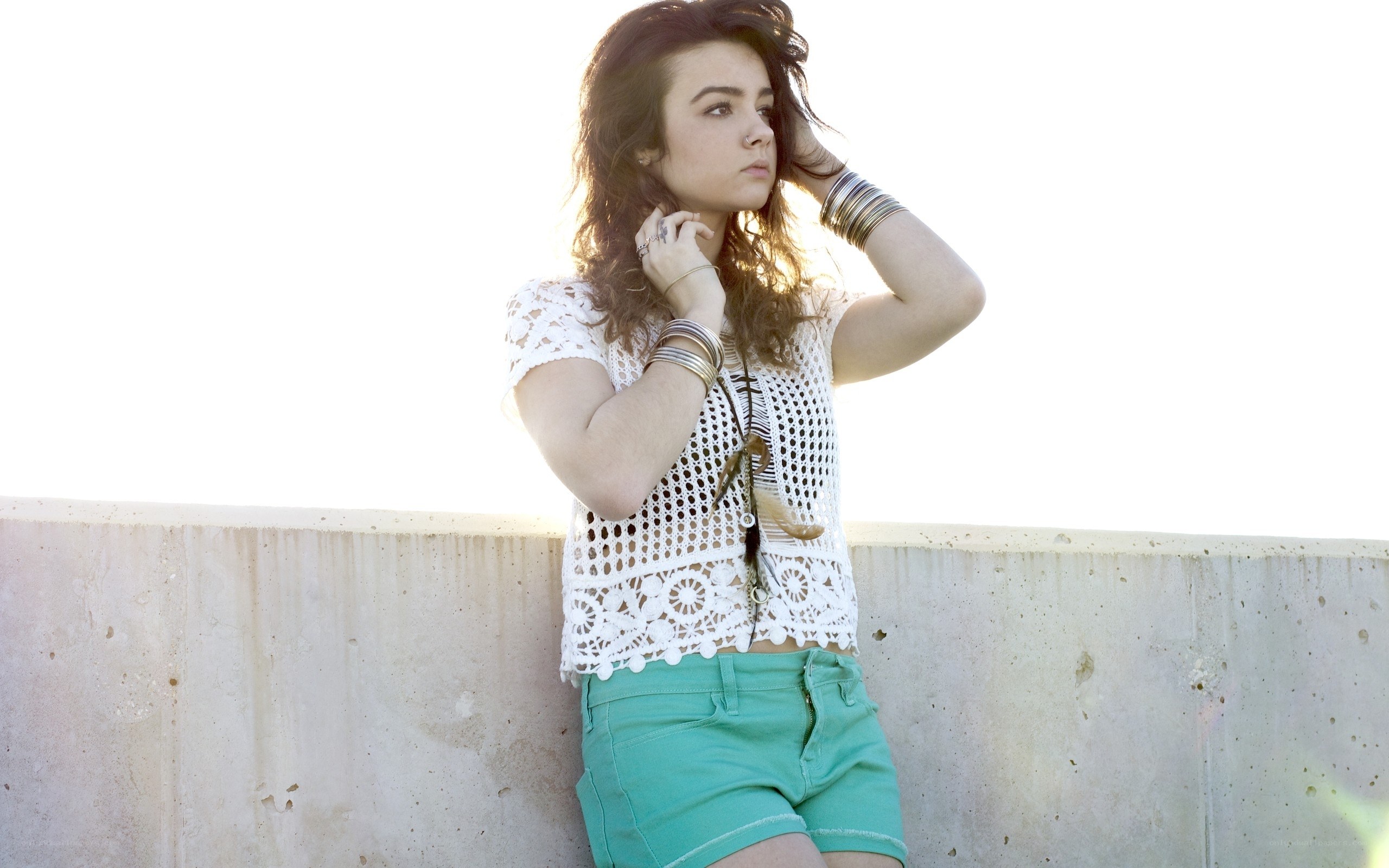 woman in white top and green shorts