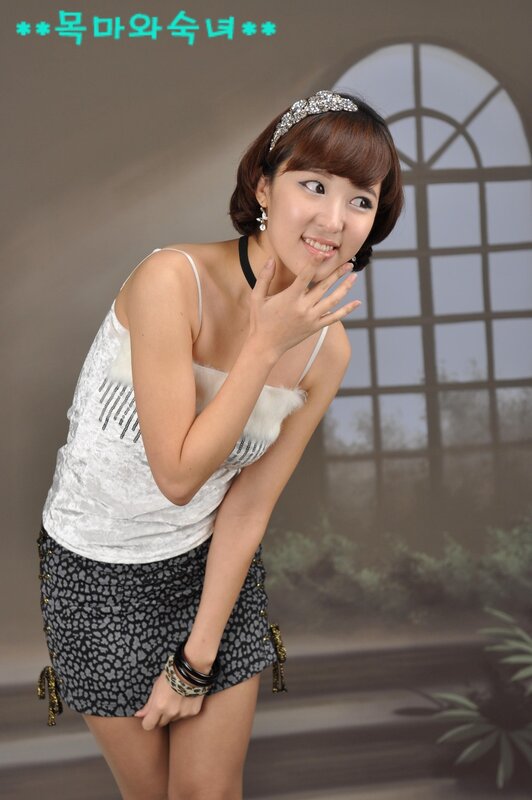 woman in white top and patterned skirt