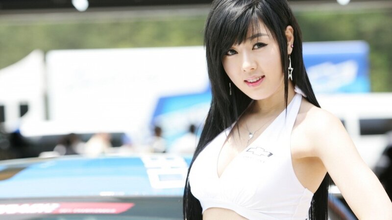 woman in white top at car event