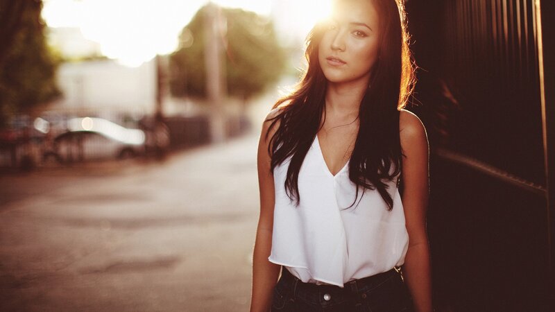 woman in white top at sunset