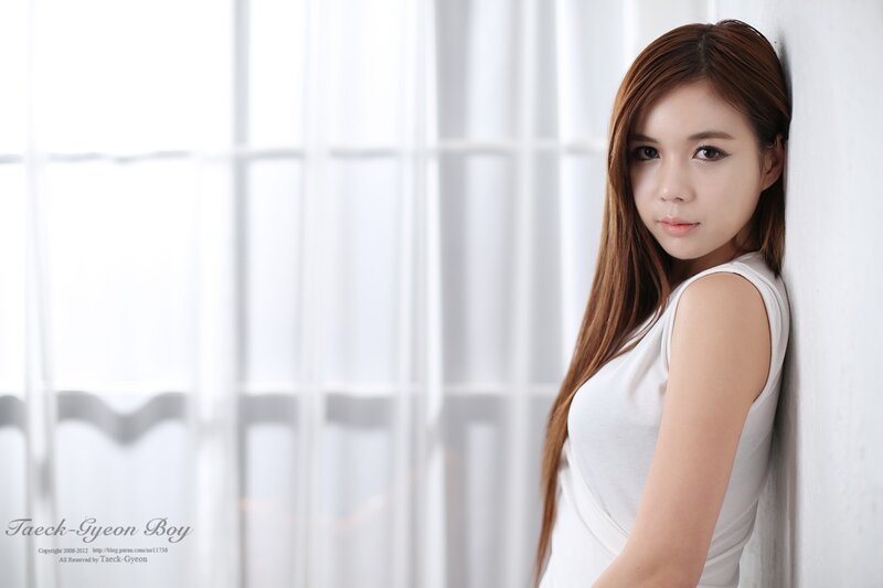 woman in white top by window