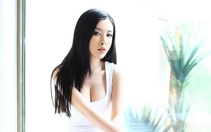 woman in white top by window