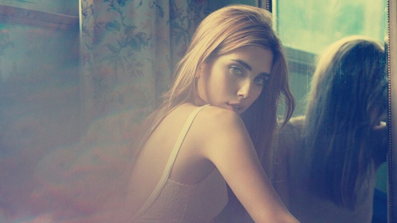 woman in white top by window
